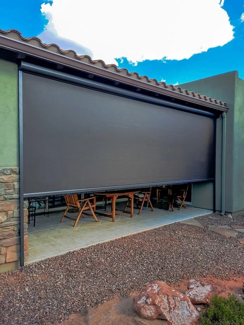 Custom motorized screen enclosing a covered patio at a Houston home